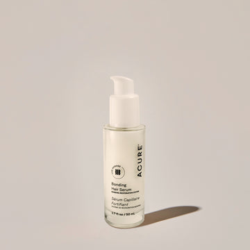 A bottle of Bonding Hair Serum with a pump dispenser, predominantly white in color with simple labeling.